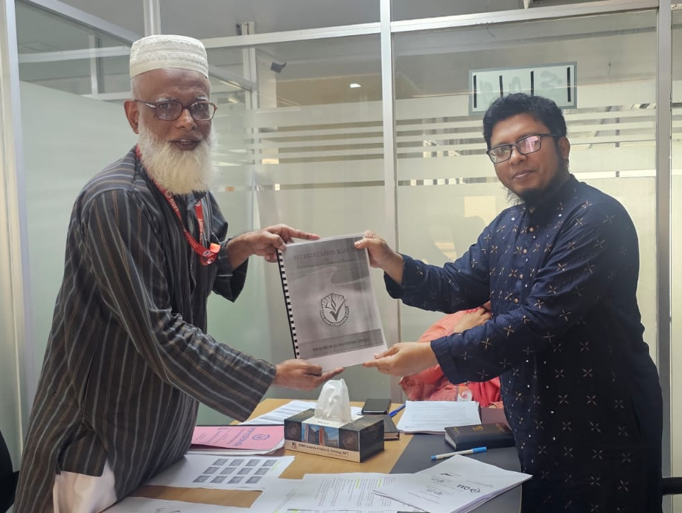 IQAC Director Hands Over BAC Accreditation Manual to Head of the Department of Business  for Accreditation Preparation.
